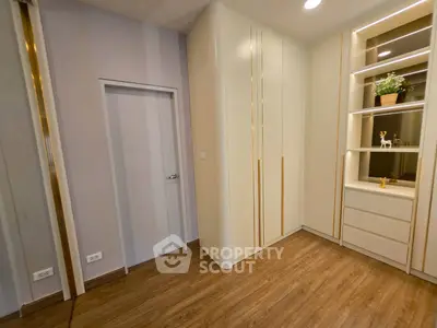 Modern bedroom with sleek built-in wardrobe and wooden flooring