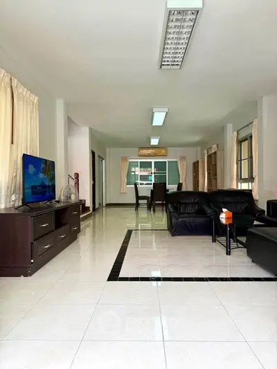 Spacious living room with modern furniture and large windows for natural light.