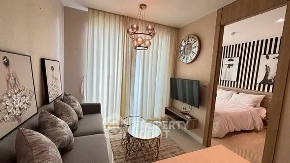 Modern living room with stylish decor and adjacent bedroom view.