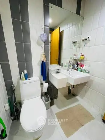 Modern bathroom with dual sinks and contemporary design.