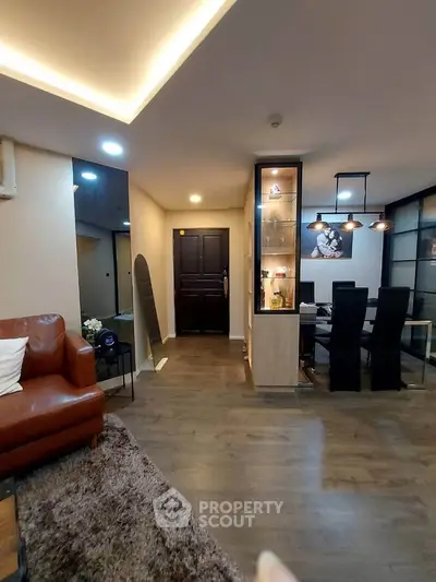 Stylish modern living room with open dining area and elegant lighting