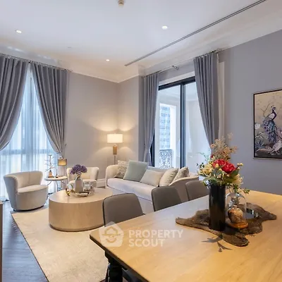 Luxurious living room with elegant decor and large windows in a modern apartment.