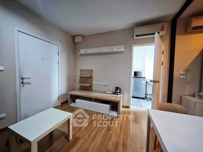 Modern living room with wooden flooring and minimalist furniture in a cozy apartment.