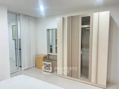 Modern bedroom with sleek wardrobe and vanity in minimalist design
