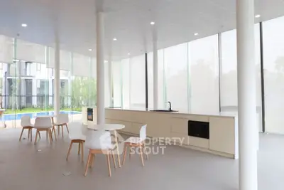 Modern open-plan kitchen with sleek design and large windows offering natural light.