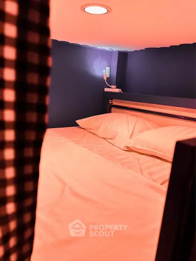 Cozy bedroom with modern lighting and comfortable bedding, perfect for relaxation.