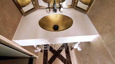 Luxurious bathroom with elegant gold sink and modern fixtures