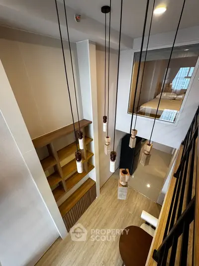 Modern loft interior with stylish lighting and wooden shelving, showcasing a chic and contemporary design.