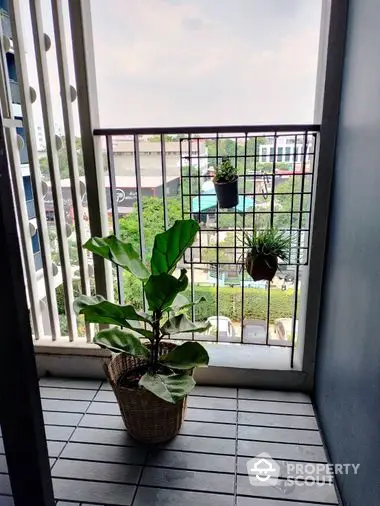 Cozy balcony space with potted plants and a serene view, perfect for relaxation and enjoying the outdoors from the comfort of your home.