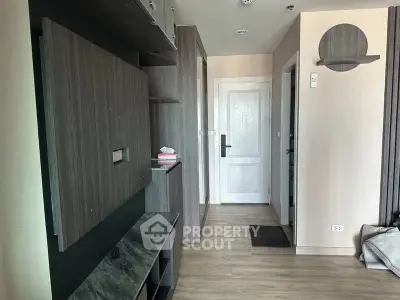 Modern apartment hallway with sleek wooden finishes and white door