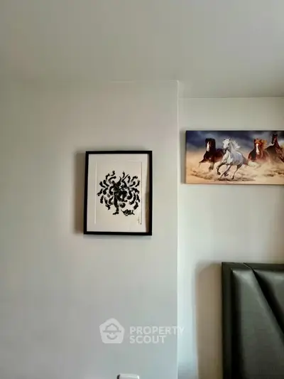 Minimalist bedroom wall with framed art and horse painting