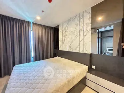 Modern bedroom with stylish marble accent wall and cozy lighting