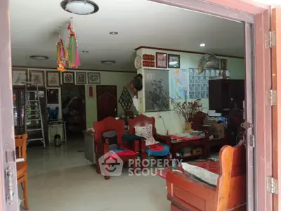 Charming living room with traditional wooden furniture and artistic decor, perfect for cozy family gatherings.