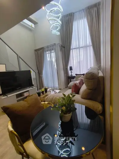 Luxurious living room with high ceilings and modern chandelier in elegant apartment