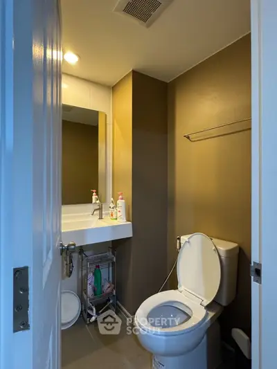 Compact bathroom with modern fixtures and neutral tones