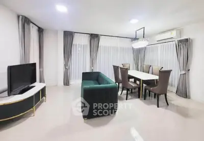 Spacious modern living room with elegant dining area and chic furnishings.