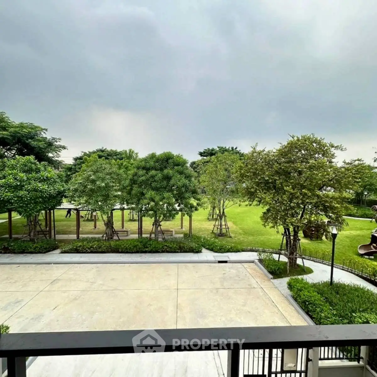 Spacious garden view from balcony in modern residential area.