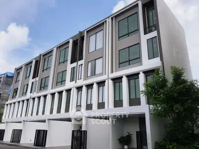Modern multi-story building with sleek design and large windows, perfect for urban living.