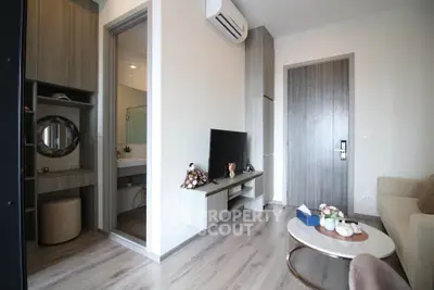 Modern living room with stylish decor and open bathroom view