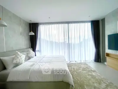 Luxurious bedroom with large windows and modern decor, offering a serene and inviting atmosphere.