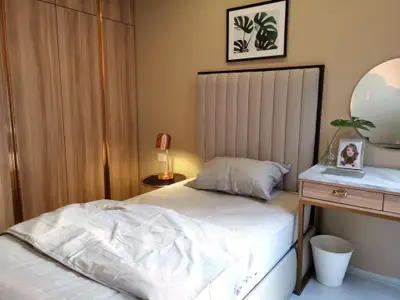 Cozy bedroom with modern decor, featuring a plush bed, stylish nightstand, and elegant wall art.