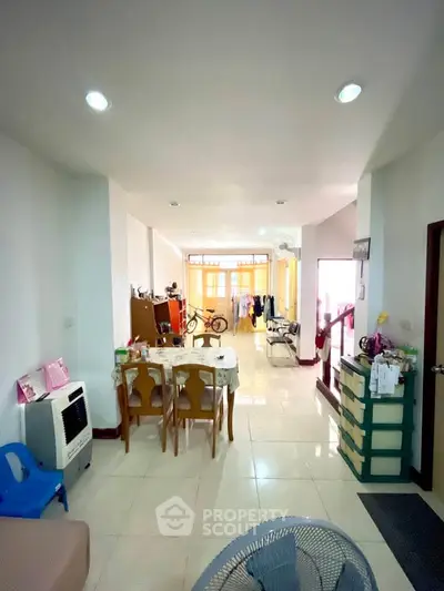 Spacious living room with dining area and natural light, perfect for family gatherings.