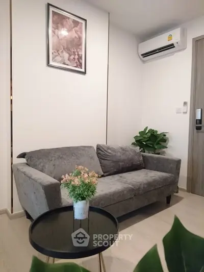 Cozy living room with plush gray sofa and modern decor, perfect for relaxation.