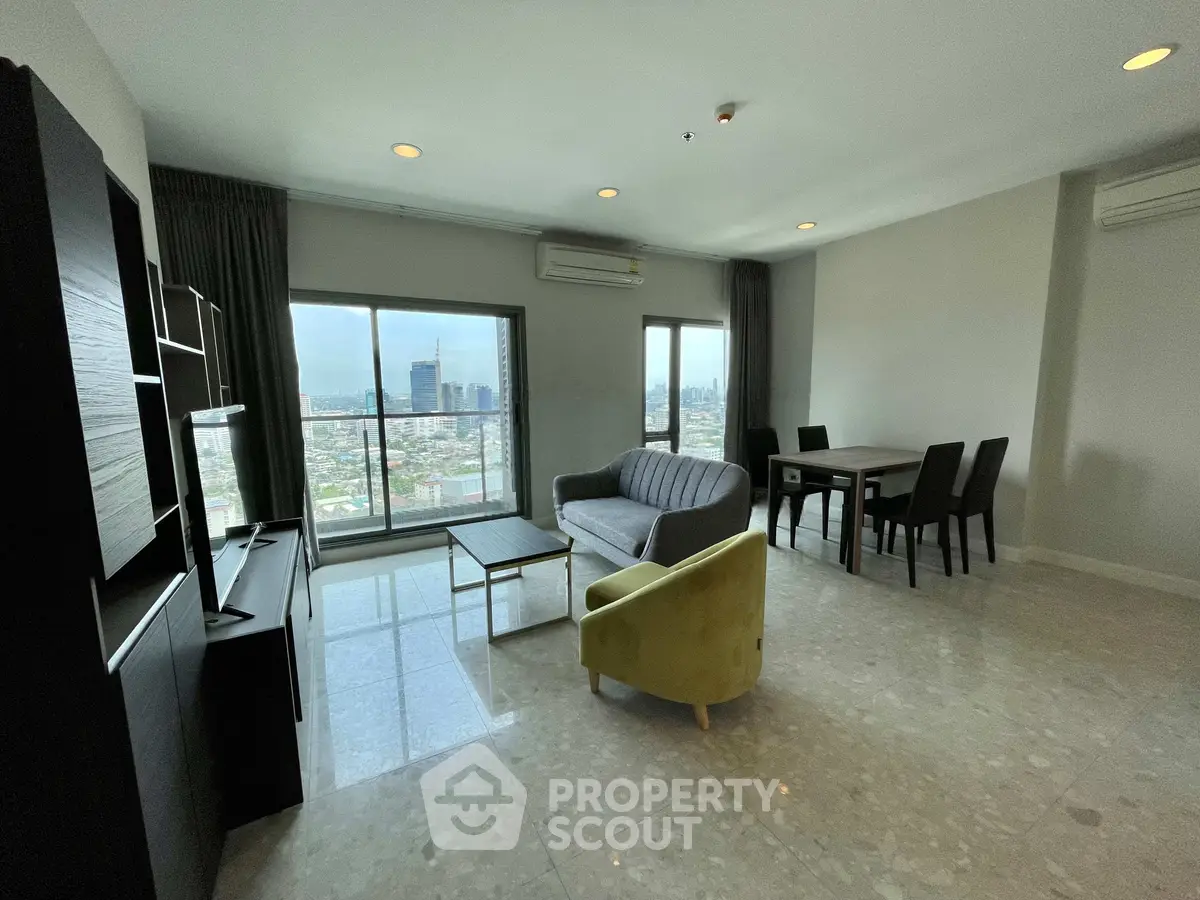 Spacious living room with city view, modern furniture, and dining area in a high-rise apartment.