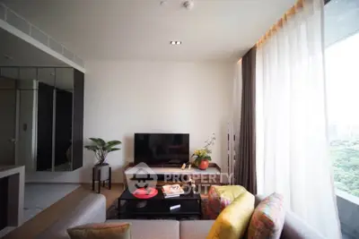 Modern living room with large window and stylish decor, offering a bright and inviting atmosphere.