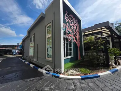 Modern building exterior with unique pink tree mural and sleek design