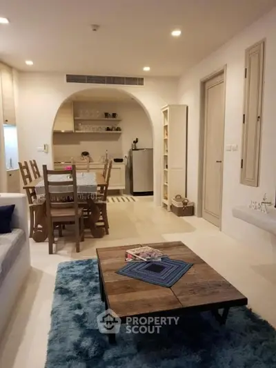 Charming open-layout living room with cozy dining area and modern kitchen