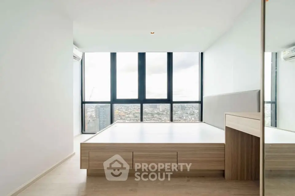 Modern minimalist bedroom with panoramic city view and sleek wooden furniture.