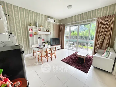 Spacious living room with modern decor and large windows overlooking greenery