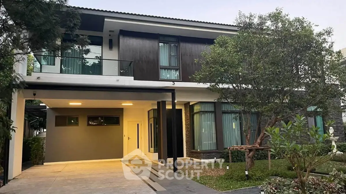 Modern two-story house with sleek design and spacious driveway, surrounded by lush greenery.