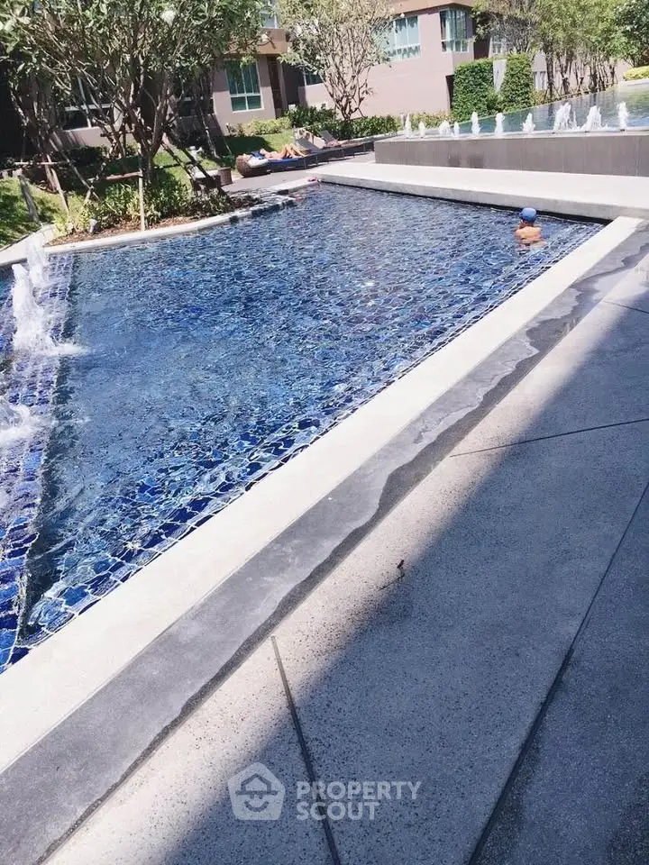 Luxurious outdoor pool area with modern design and lush greenery, perfect for relaxation and leisure.