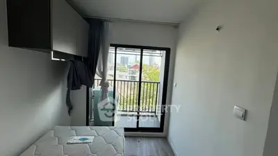 Compact bedroom with balcony view in modern apartment