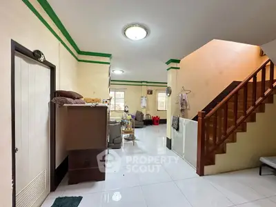 Spacious living area with staircase and modern lighting in a cozy home