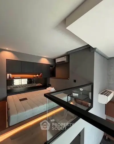 Modern bedroom with sleek design and ambient lighting in a stylish apartment.