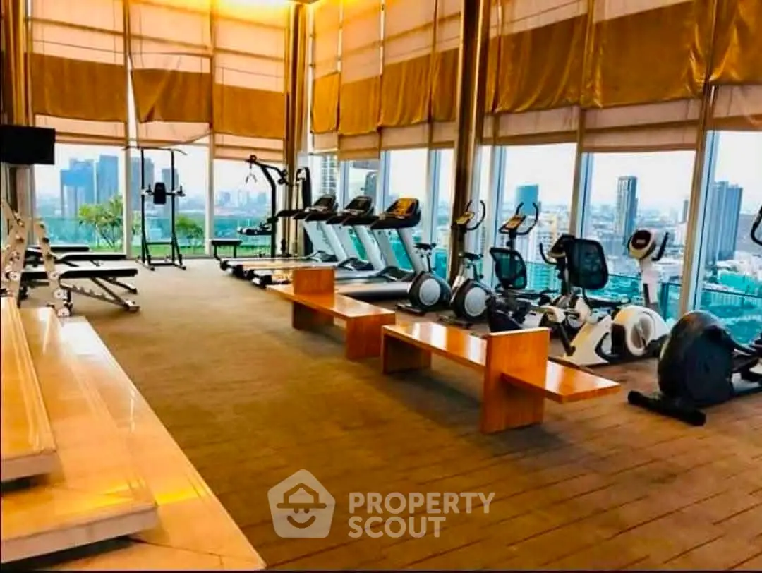 Luxurious high-rise gym with panoramic city views and modern fitness equipment.