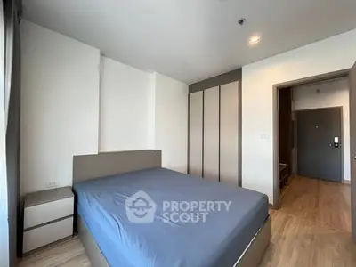 Modern bedroom with sleek design and ample storage in a stylish apartment.