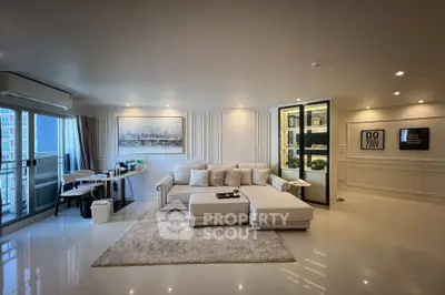 Luxurious modern living room with elegant decor and spacious layout, featuring a cozy sectional sofa and stylish wall art.