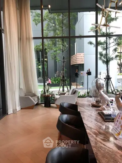 Luxurious modern living room with floor-to-ceiling windows and elegant decor.