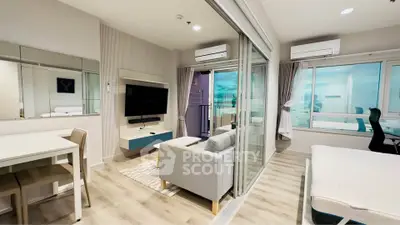 Modern living room with sleek furniture and balcony view in a stylish apartment.