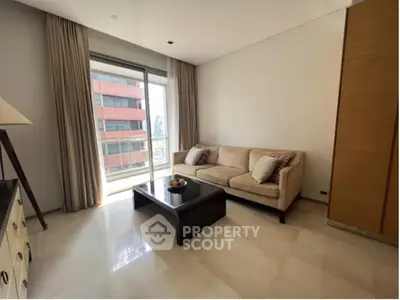 Modern living room with large window and city view, featuring a comfortable sofa and stylish decor.