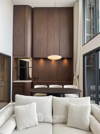 Luxurious modern living room with high ceilings and elegant wooden cabinetry