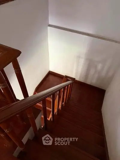 Elegant wooden staircase with polished handrails in a cozy home interior