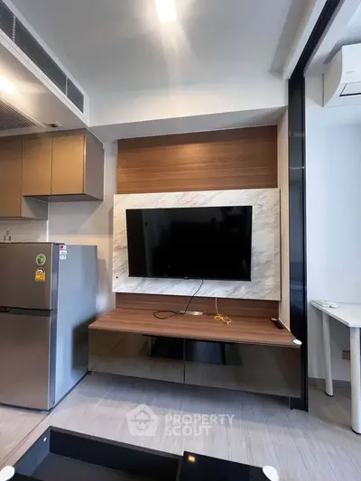 Modern living room with sleek TV setup and stylish cabinetry