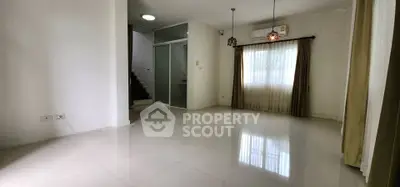 Spacious empty living room with modern lighting and large windows