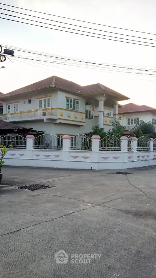 Charming two-story house with fenced yard and elegant balcony in a serene neighborhood.