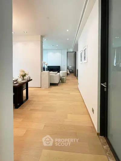 Spacious modern living room with elegant decor and wooden flooring, perfect for luxury living.